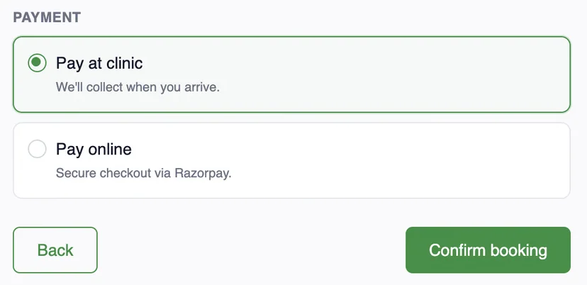 Payment options on the review screen: pay at clinic, or pay online with secure checkout via Razorpay, then confirm booking